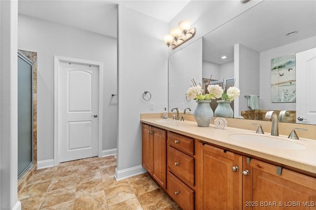 bathroom with a shower with door and vanity