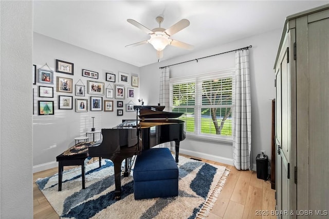 misc room with ceiling fan and light hardwood / wood-style floors