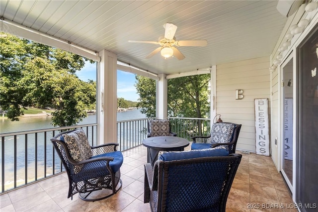 exterior space with ceiling fan and a water view