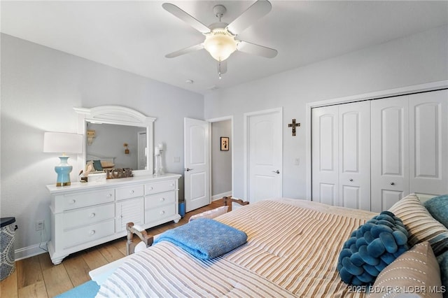 bedroom featuring a closet, light hardwood / wood-style floors, and ceiling fan