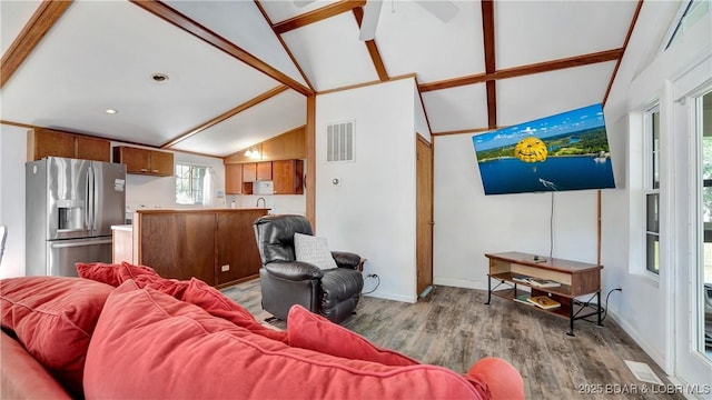 living room featuring light wood-type flooring and vaulted ceiling