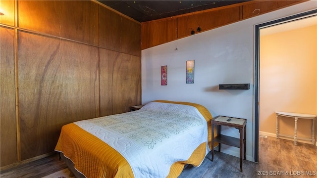 bedroom with dark hardwood / wood-style flooring