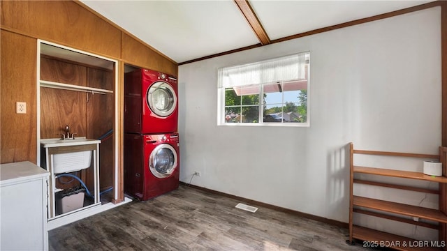 laundry area with dark wood-type flooring and stacked washer and clothes dryer