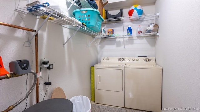 clothes washing area featuring washing machine and clothes dryer