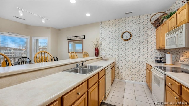 kitchen with sink, light tile patterned flooring, and white appliances