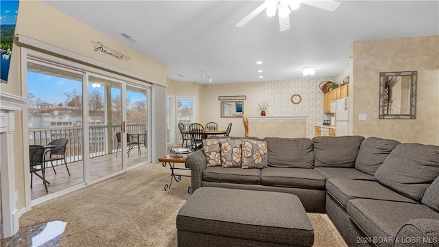 carpeted living room featuring ceiling fan