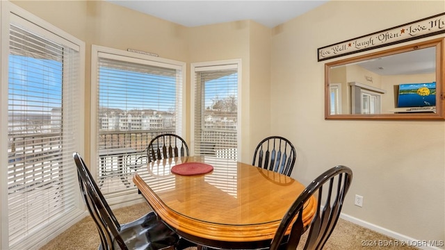 carpeted dining space with a healthy amount of sunlight