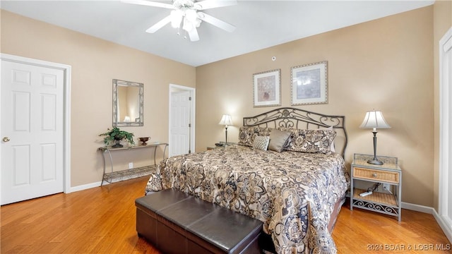 bedroom with ceiling fan and hardwood / wood-style flooring