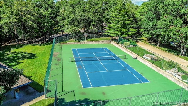 view of sport court featuring a lawn