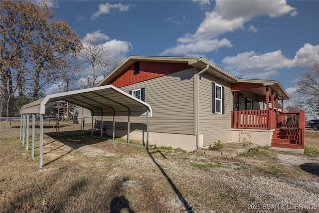 view of home's exterior featuring a carport and a porch