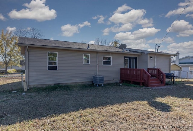 rear view of property featuring central AC unit, a wooden deck, and a lawn