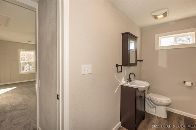 bathroom with vanity, wood-type flooring, and toilet