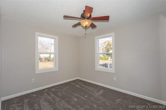 carpeted spare room with a wealth of natural light, ceiling fan, and a textured ceiling