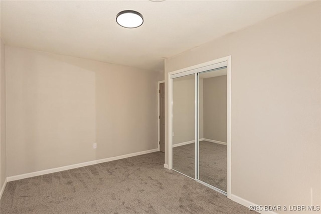 unfurnished bedroom featuring carpet floors and a closet