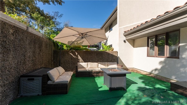 view of patio / terrace featuring an outdoor living space with a fire pit