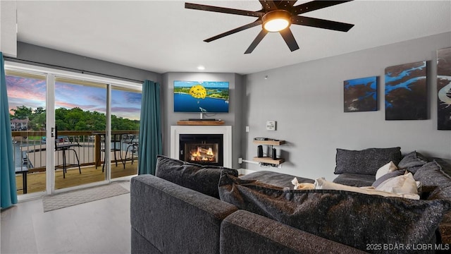 living room featuring ceiling fan and wood-type flooring