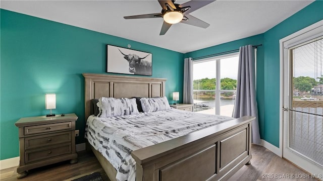 bedroom with ceiling fan and dark hardwood / wood-style floors