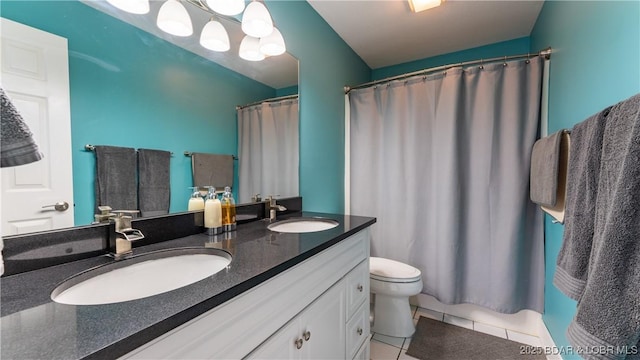 bathroom featuring toilet, vanity, tile patterned flooring, and walk in shower