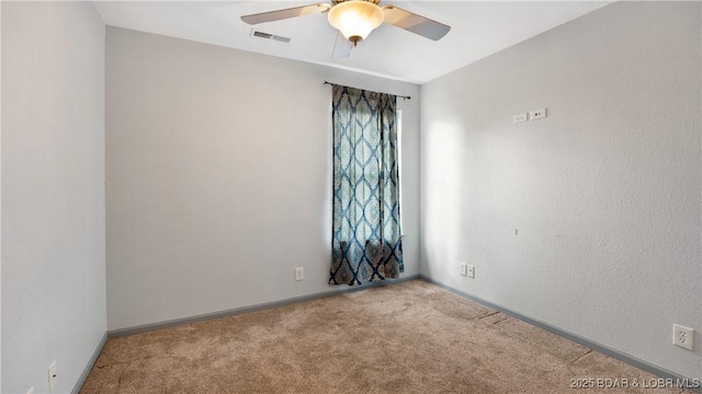 unfurnished room featuring ceiling fan and light colored carpet