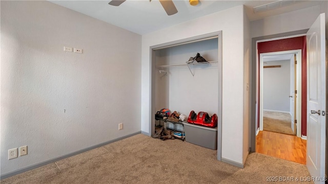 carpeted bedroom featuring a closet and ceiling fan