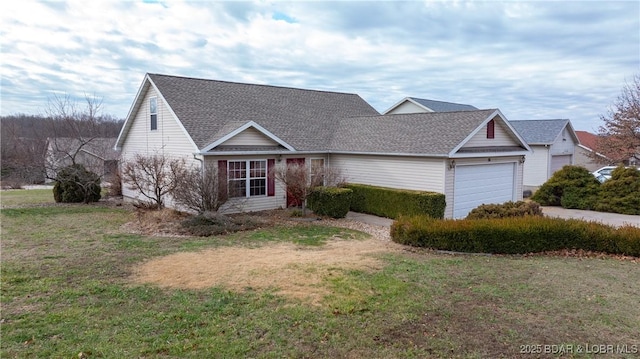 view of front of property with a front lawn and a garage