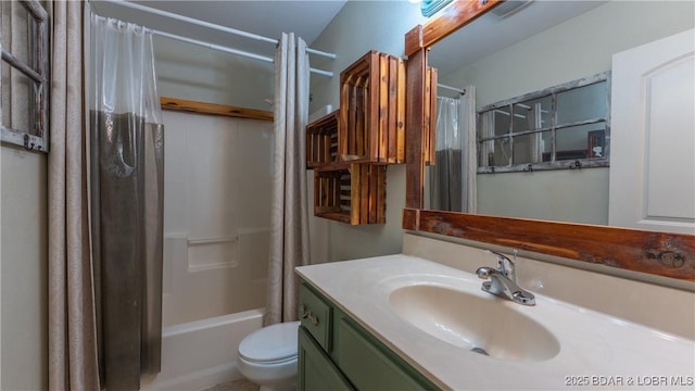 full bathroom featuring vanity, shower / tub combo, and toilet