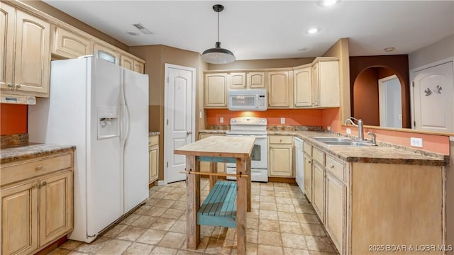 kitchen with sink, butcher block countertops, pendant lighting, white appliances, and light brown cabinetry