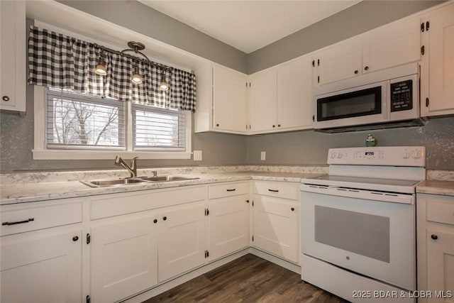 kitchen featuring white cabinetry, sink, dark hardwood / wood-style floors, pendant lighting, and white appliances