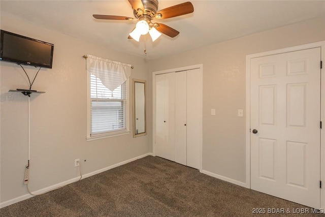 unfurnished bedroom with ceiling fan, a closet, and dark colored carpet