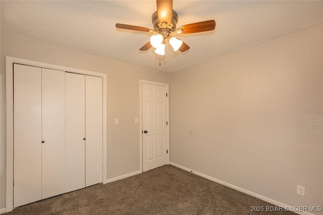 unfurnished bedroom with ceiling fan, a closet, and dark carpet