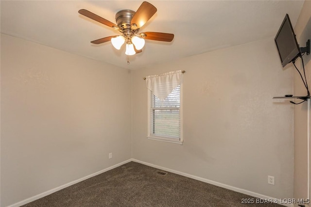 carpeted spare room with ceiling fan