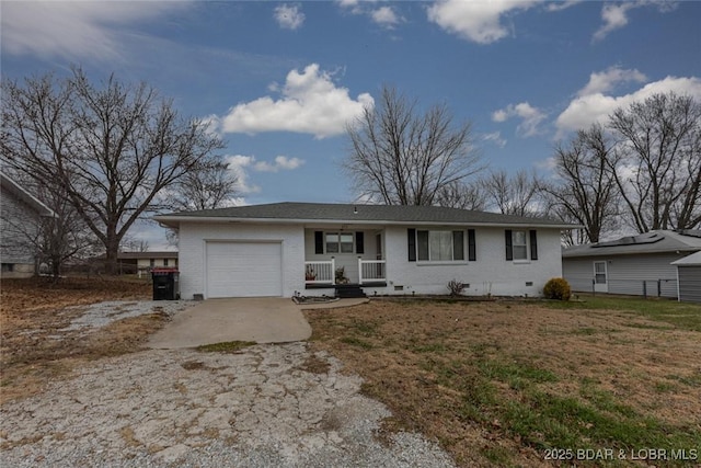 ranch-style house featuring a garage and covered porch