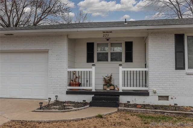 doorway to property featuring a garage and covered porch