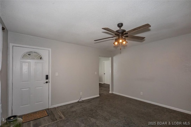 carpeted entryway featuring ceiling fan and a textured ceiling