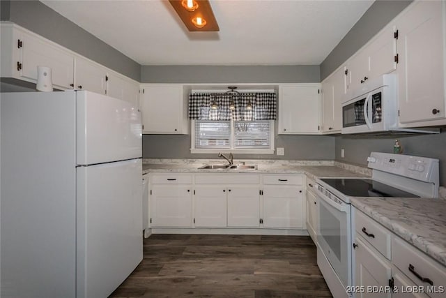 kitchen featuring white cabinets, white appliances, and sink