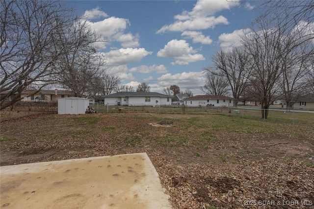 view of yard with a storage unit and a patio area