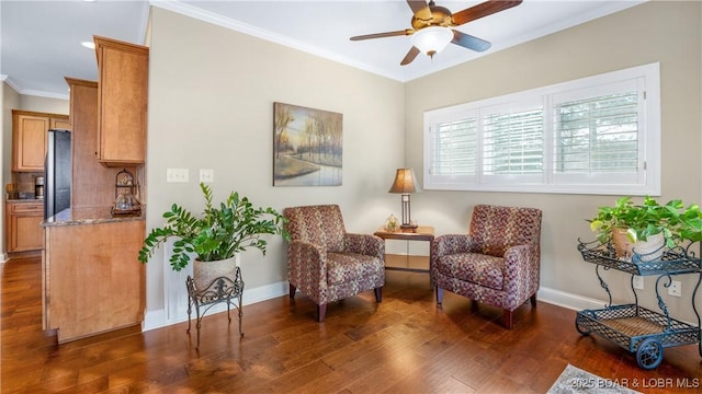 living area with crown molding, ceiling fan, and dark wood-type flooring