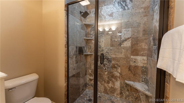 bathroom with an enclosed shower and toilet