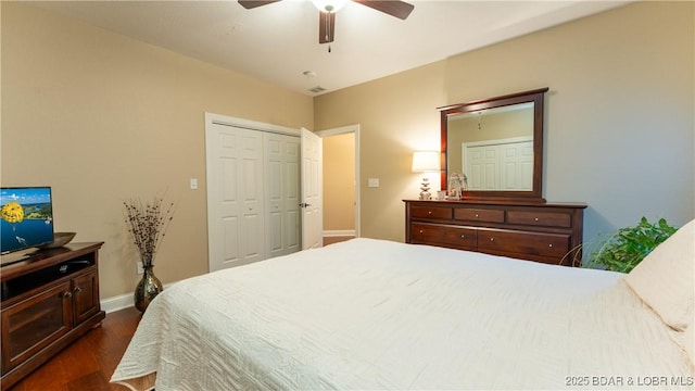 bedroom featuring ceiling fan, dark hardwood / wood-style flooring, and a closet