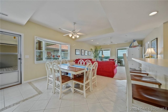 dining space featuring ceiling fan and light tile patterned floors