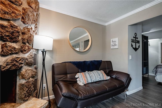 living room featuring dark hardwood / wood-style flooring, a textured ceiling, and ornamental molding