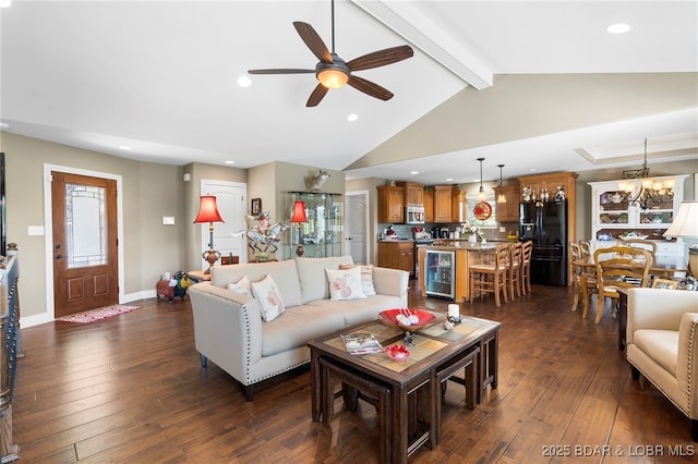 living room featuring vaulted ceiling with beams, ceiling fan with notable chandelier, dark wood-type flooring, and beverage cooler