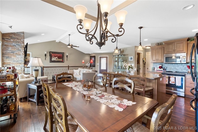 dining space with ceiling fan with notable chandelier, dark hardwood / wood-style flooring, and vaulted ceiling with beams