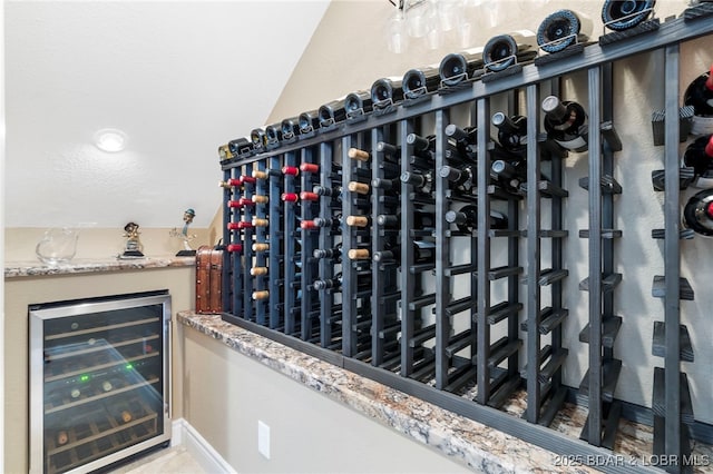 wine area with beverage cooler and lofted ceiling