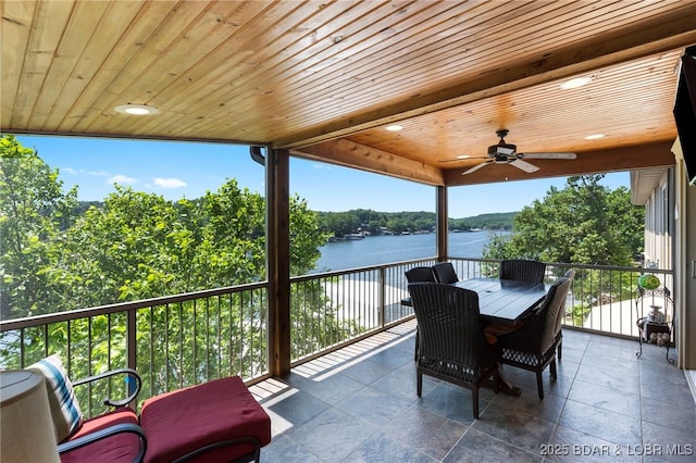 view of patio / terrace featuring ceiling fan, a balcony, and a water view