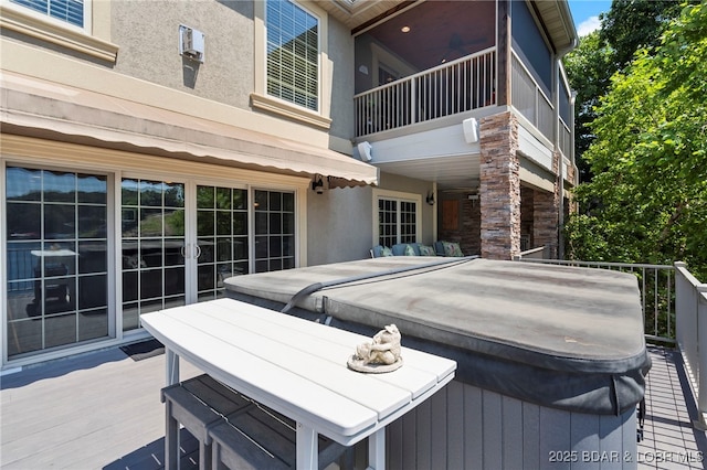 deck with a covered hot tub and ceiling fan