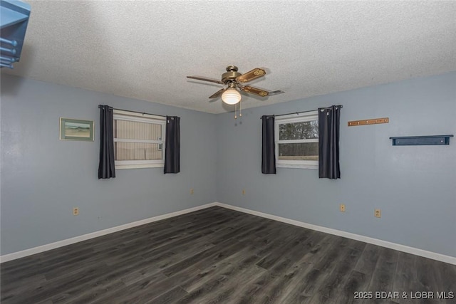 spare room with dark hardwood / wood-style floors, ceiling fan, and a textured ceiling