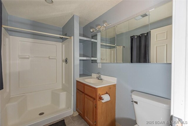 bathroom featuring vanity, tile patterned flooring, a shower with shower curtain, and toilet