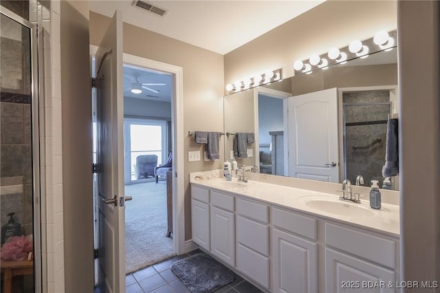 bathroom featuring tile patterned flooring, vanity, and an enclosed shower