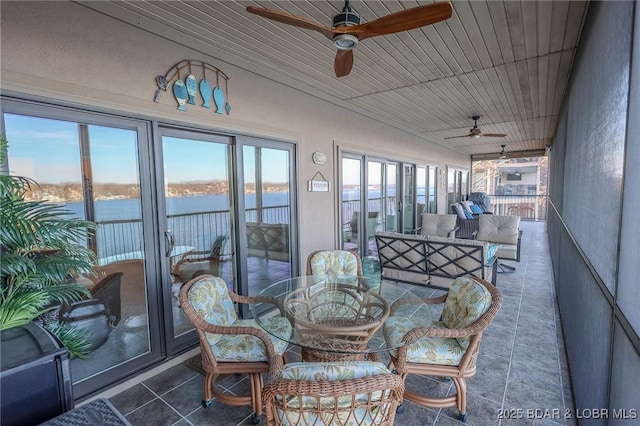 sunroom / solarium with a water view and wooden ceiling